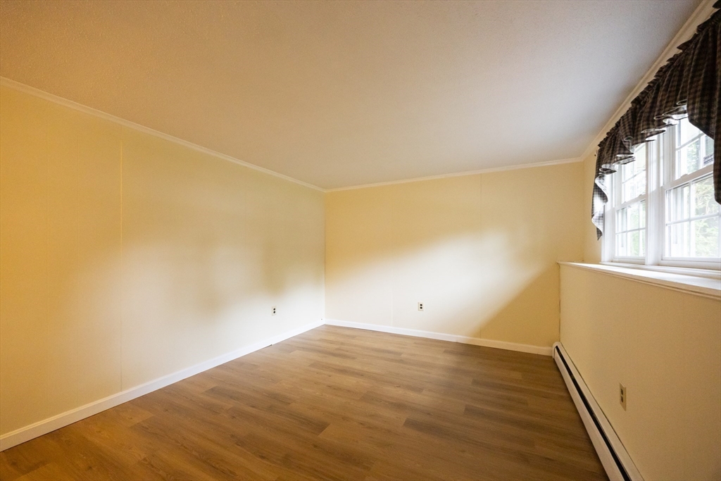 6 Clearview Drive Milford, MA 01757 - Photo 37 of 42 an empty room with wooden floor and windows
