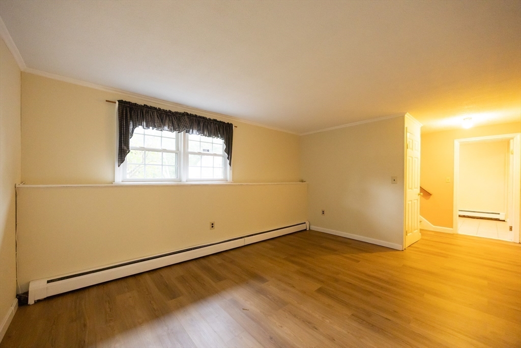 6 Clearview Drive Milford, MA 01757 - Photo 38 of 42 an empty room with wooden floor and windows