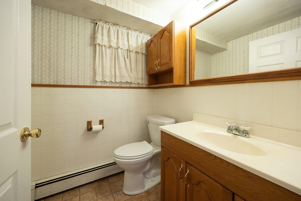 6 Clearview Drive Milford, MA 01757 - Photo 40 of 42 a bathroom with a sink a toilet and a mirror