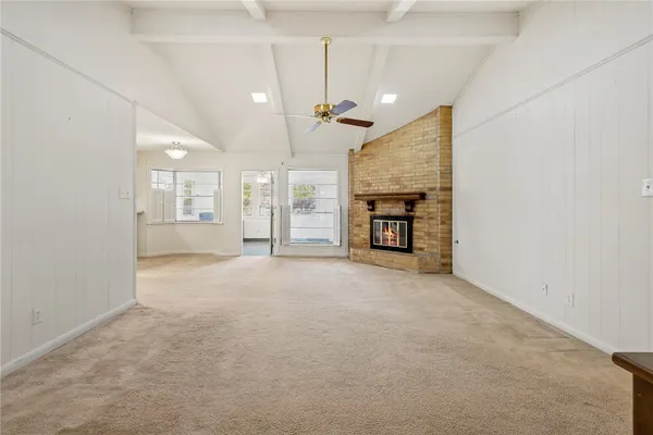 a view of an empty room with a fireplace