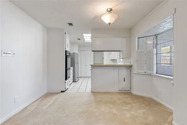 a kitchen with a sink appliances and cabinets