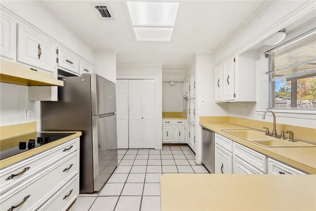 a spacious bathroom with a granite countertop sink mirror and a bathtub