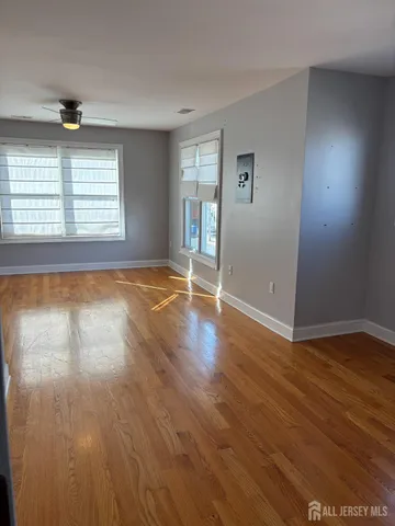 an empty room with wooden floor and closet