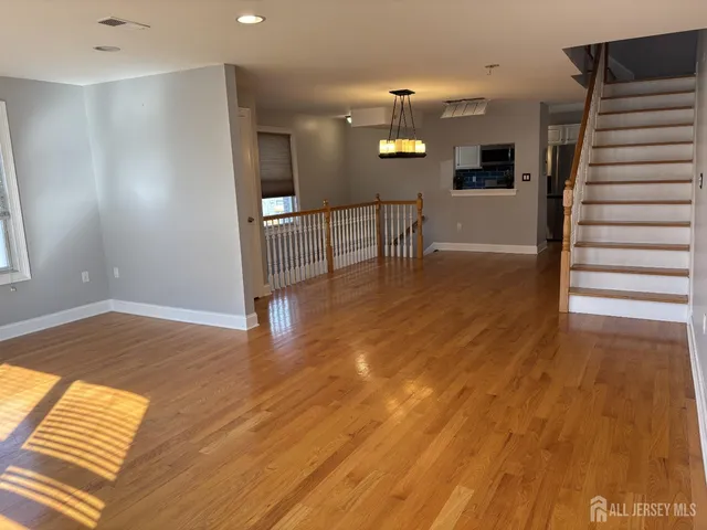 a view of a room with wooden floor and a window