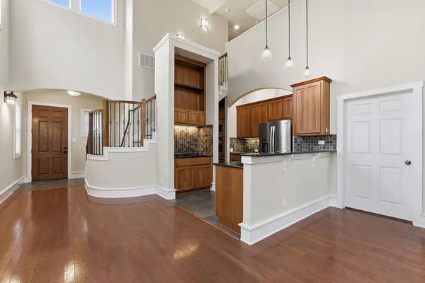 a kitchen with a refrigerator a stove and cabinets