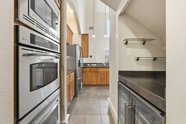 a kitchen with stainless steel appliances granite countertop a stove a sink and a refrigerator