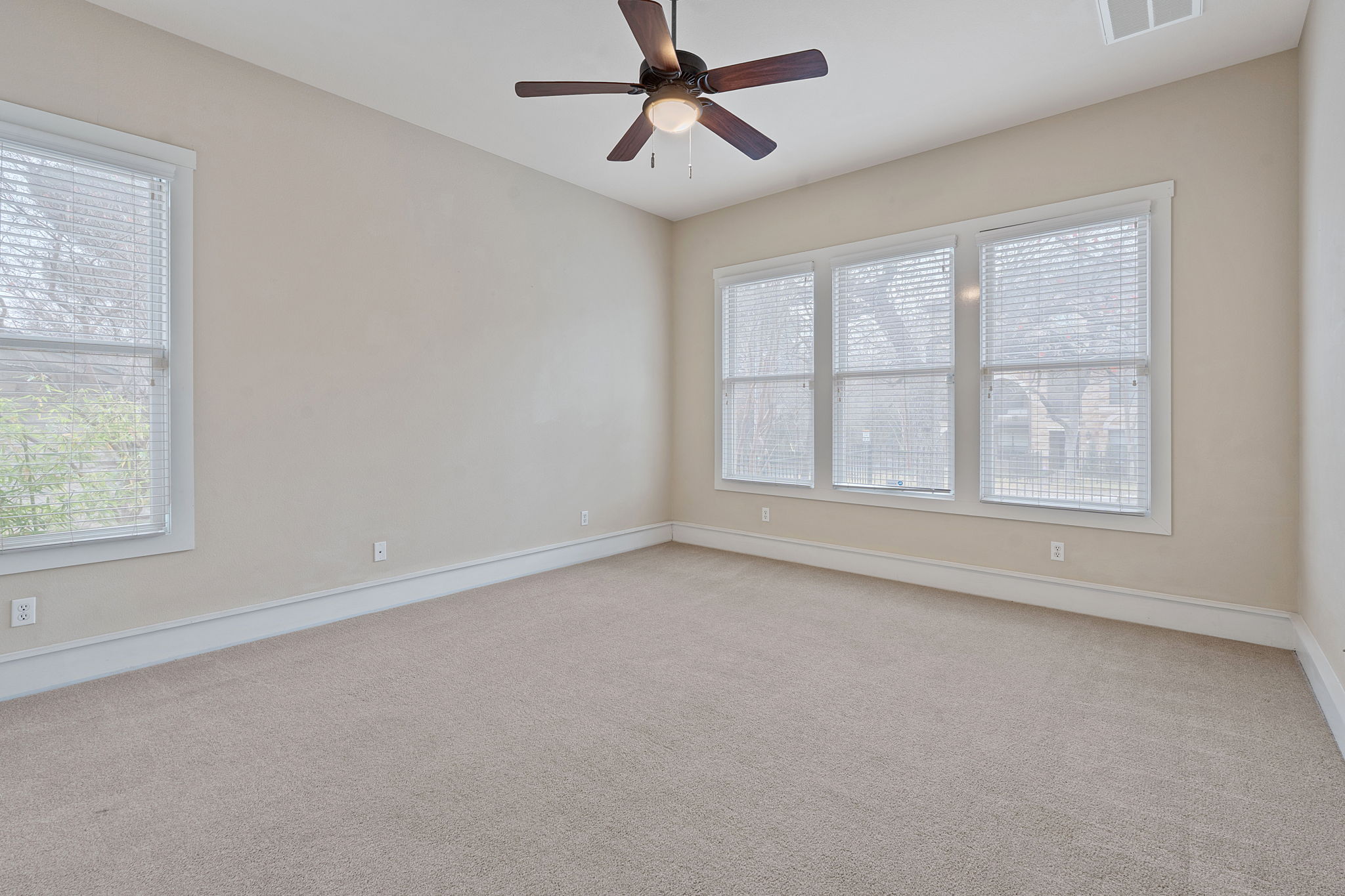 2506 Enfield Road, Unit B Austin, TX 78703 - Photo 19 of 40 an empty room with a window and a ceiling fan
