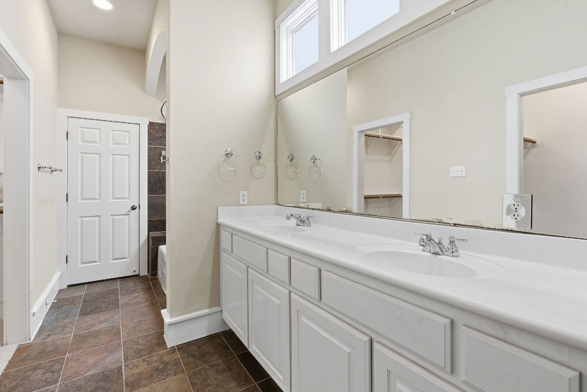 2506 Enfield Road, Unit B Austin, TX 78703 - Photo 21 of 40 Bathroom featuring double vanity, a walk in closet, and bathtub / shower combination