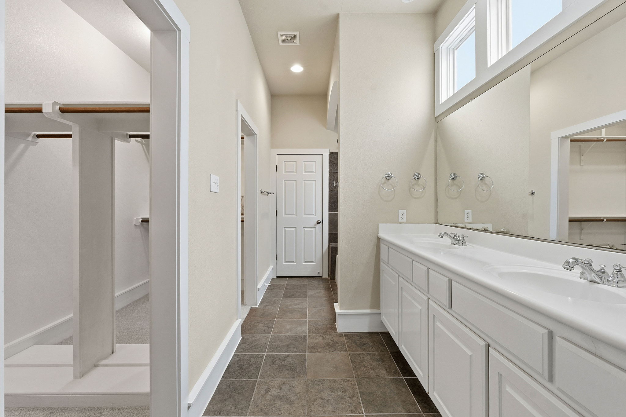 2506 Enfield Road, Unit B Austin, TX 78703 - Photo 22 of 40 a spacious bathroom with a double vanity sink and mirror
