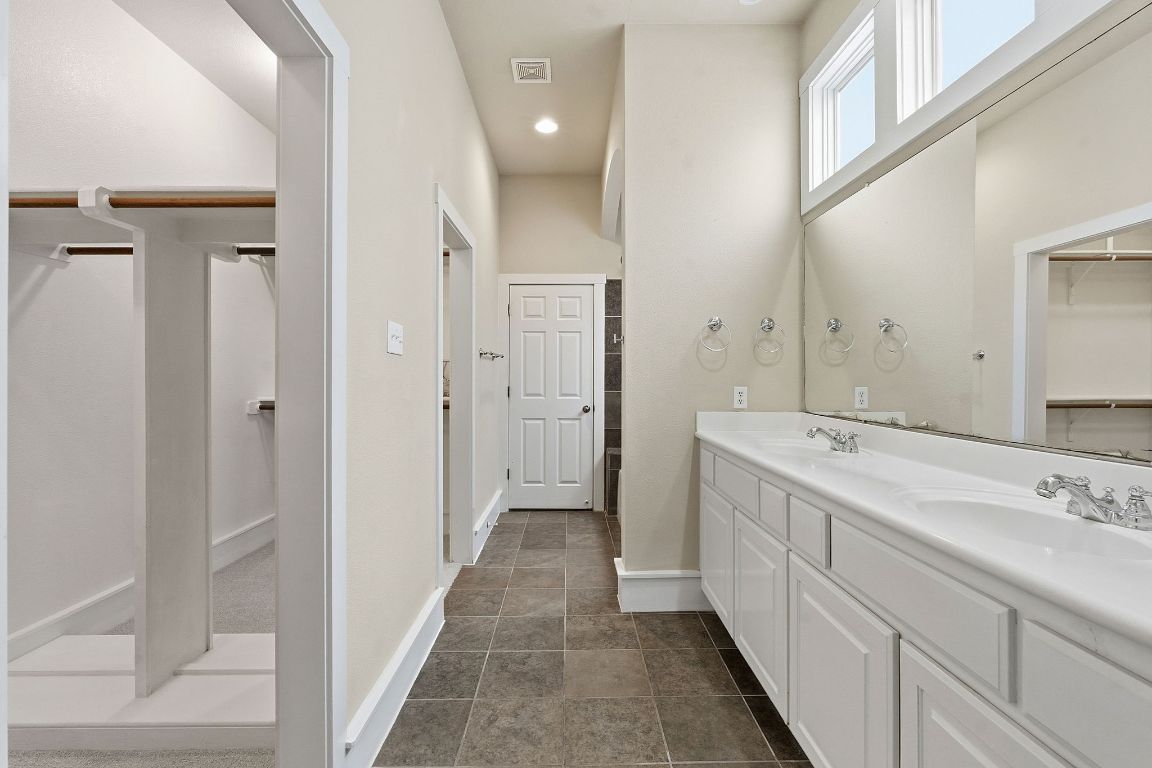 2506 Enfield Road, Unit B Austin, TX 78703 - Photo 22 of 40 Full bath with a walk in closet, double vanity, and recessed lighting