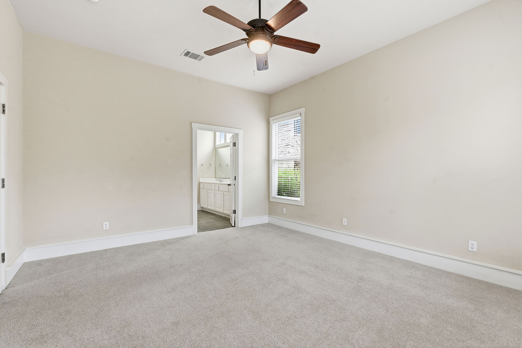2506 Enfield Road, Unit B Austin, TX 78703 - Photo 27 of 40 an empty room with windows and fan