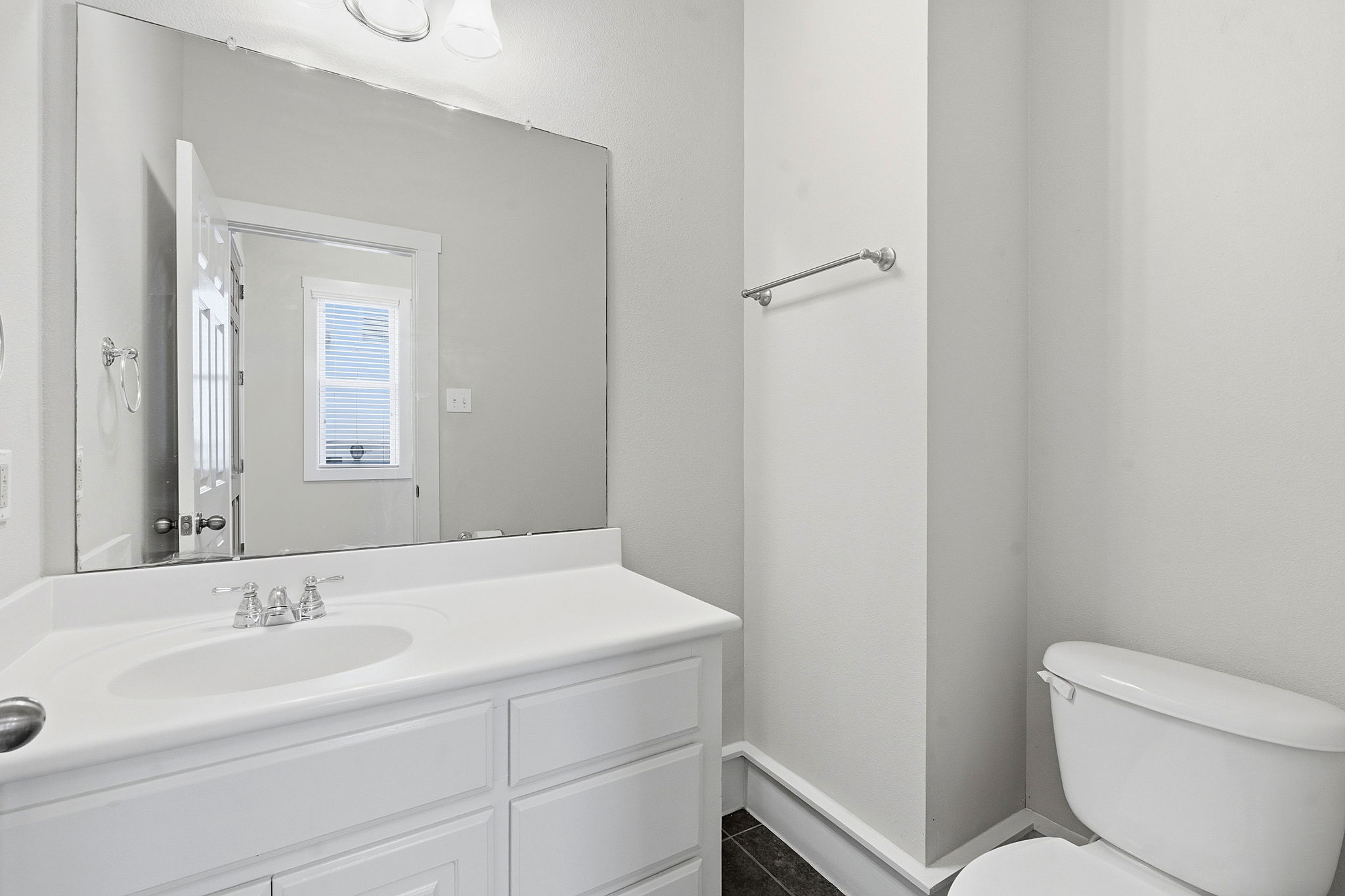 2506 Enfield Road, Unit B Austin, TX 78703 - Photo 36 of 40 a bathroom with a toilet sink and mirror