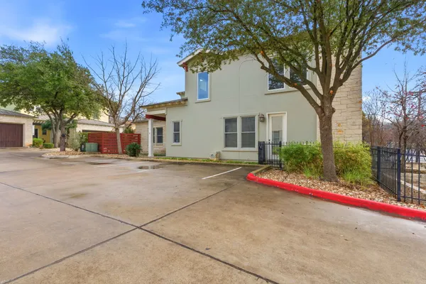 a kitchen with stainless steel appliances granite countertop a refrigerator a oven and a fireplace with wooden floor