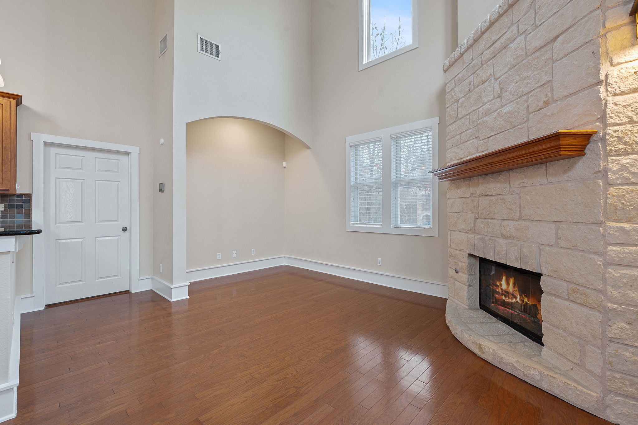 2506 Enfield Road, Unit B Austin, TX 78703 - Photo 7 of 40 an empty room with wooden floor fireplace and windows