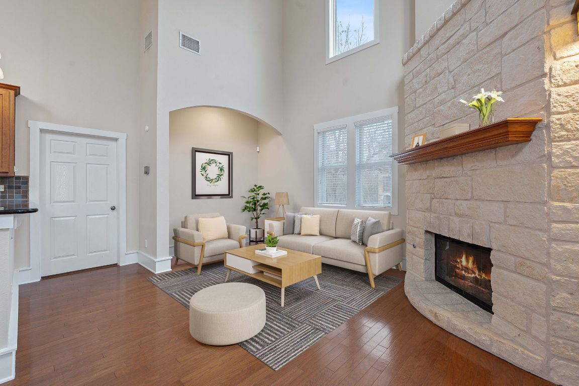 2506 Enfield Road, Unit B Austin, TX 78703 - Photo 8 of 40 Living area with dark wood-style flooring, a fireplace, plenty of natural light, and a high ceiling