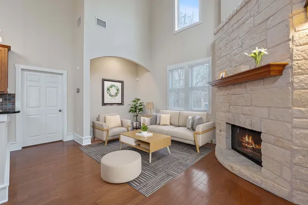 a view of a livingroom with wooden floor and a fireplace