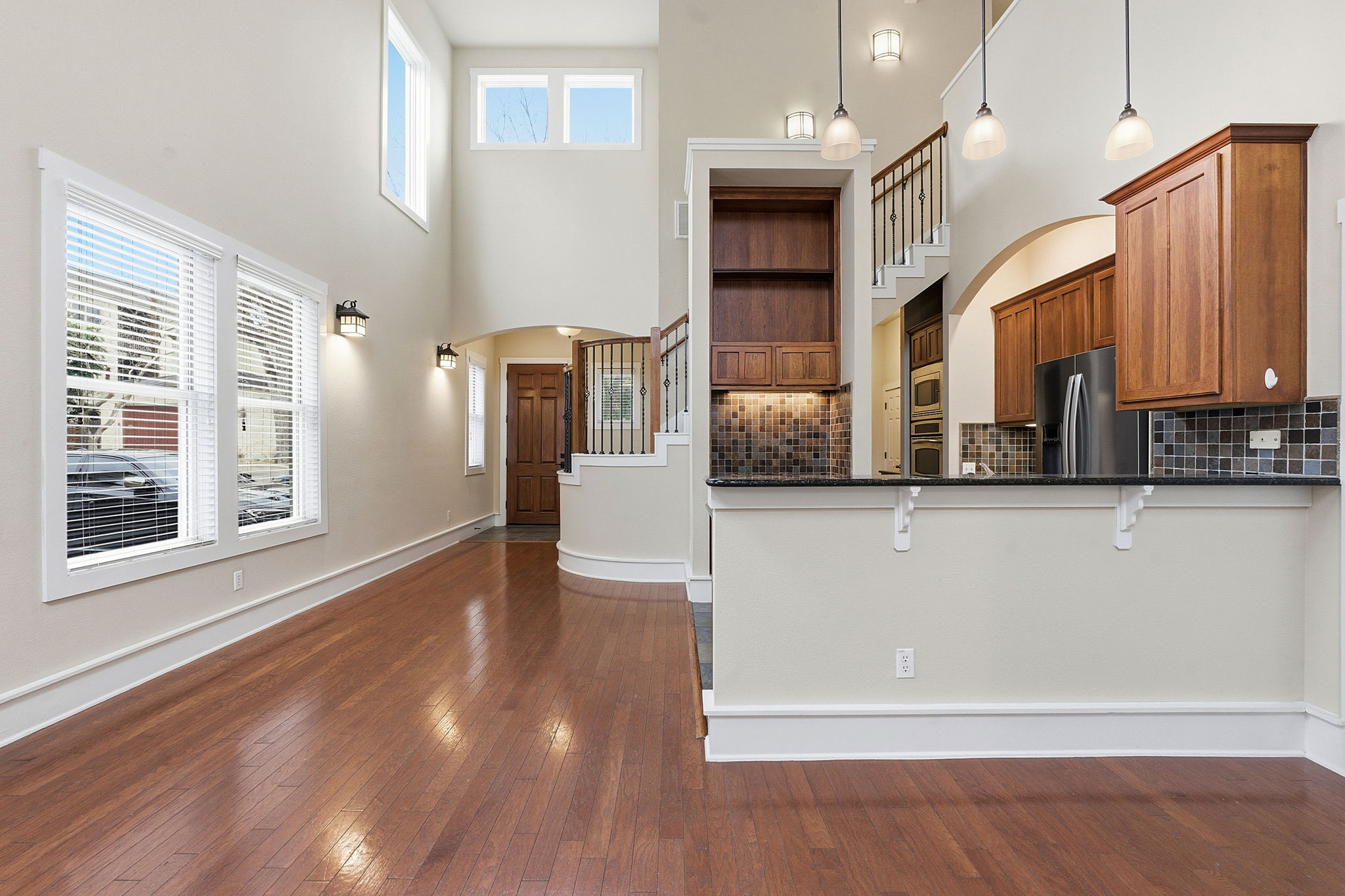 2506 Enfield Road, Unit B Austin, TX 78703 - Photo 10 of 40 a view of a kitchen with a refrigerator wooden floor and a window