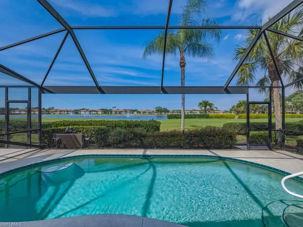 a swimming pool with outdoor seating and yard