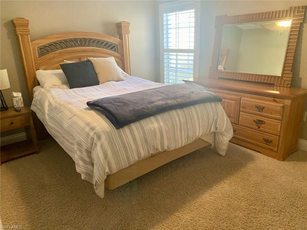 9035 Spring Run Boulevard Estero, FL 34135 - Photo 7 of 9 Bedroom featuring light colored carpet