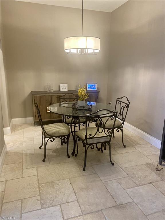 9035 Spring Run Boulevard Estero, FL 34135 - Photo 8 of 9 Dining space with stone tile flooring and baseboards
