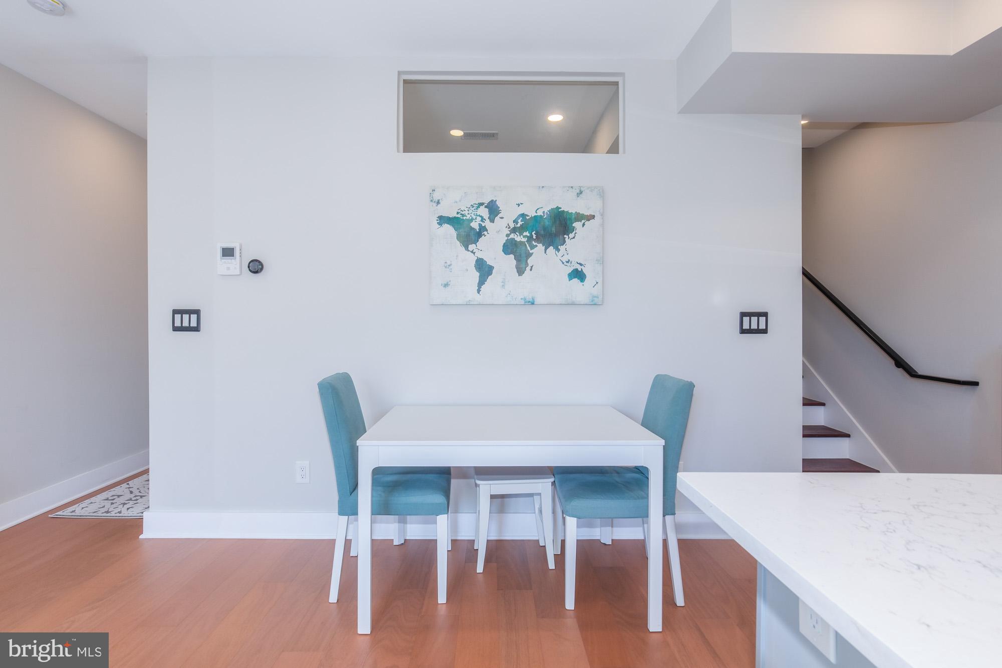 1444 Harvard Street Northwest, Unit 302 Washington, DC 20009 - Photo 20 of 50 a view of a dining room with furniture and wooden floor