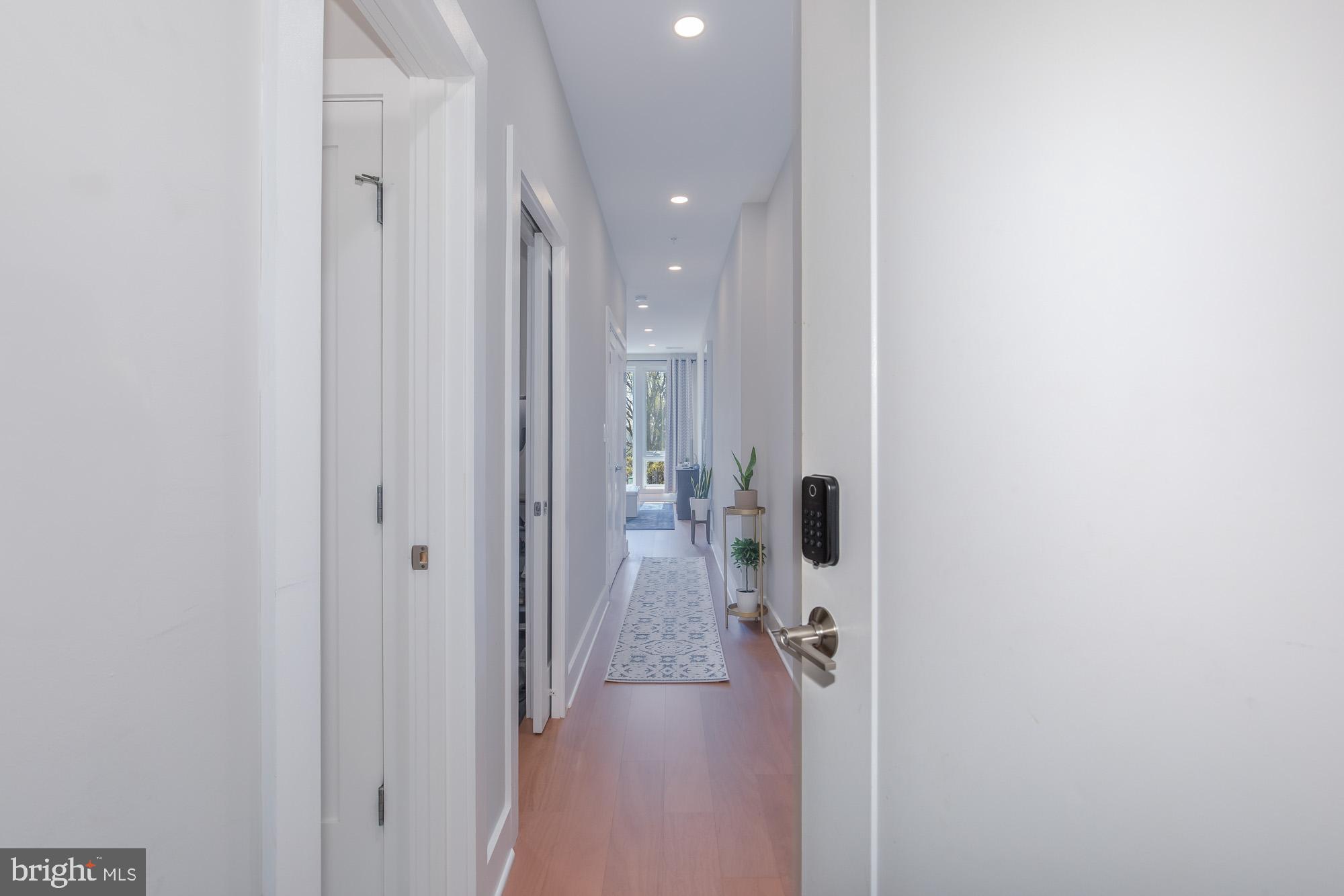 1444 Harvard Street Northwest, Unit 302 Washington, DC 20009 - Photo 21 of 50 a view of a hallway with a livingroom and a bathroom