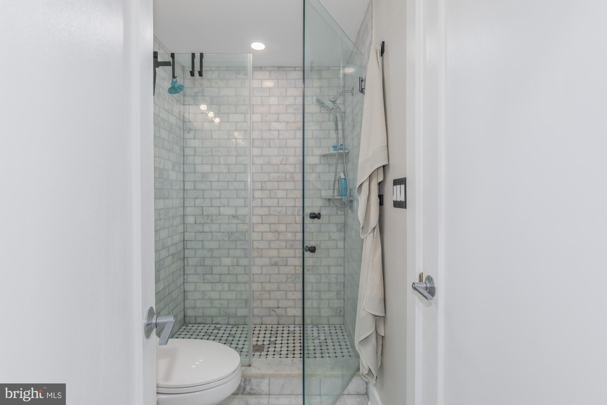 1444 Harvard Street Northwest, Unit 302 Washington, DC 20009 - Photo 31 of 50 a bathroom with a toilet and shower