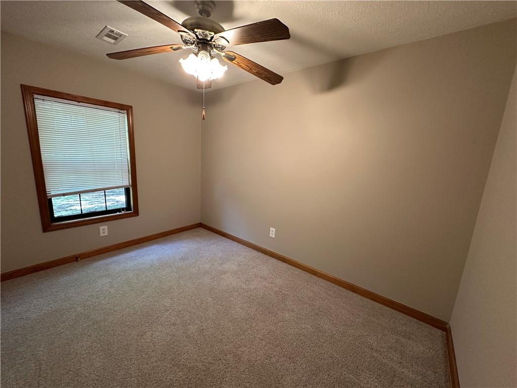 710 Spiva Road Temple, GA 30179 - Photo 22 of 31 an empty room with windows and fan