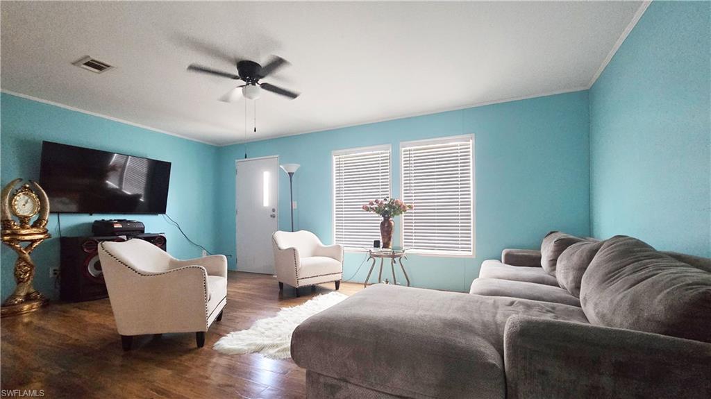 612 Hunting Clb Avenue Montura Ranches, FL 33440 - Photo 20 of 49 a living room with furniture and a flat screen tv