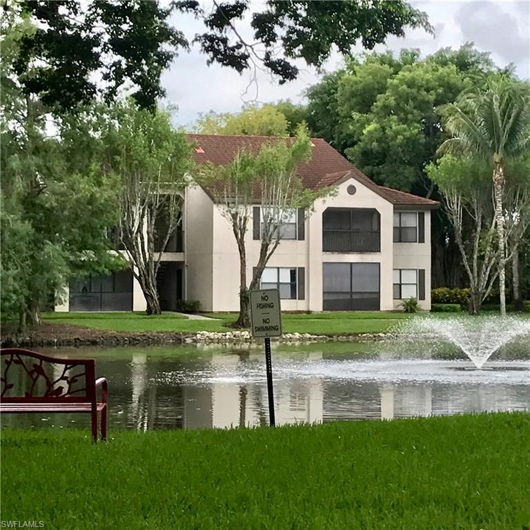 2214 Arbour Walk Circle, Unit 2012 Naples, FL 34109 - Photo 1 of 17 a front view of a house with garden
