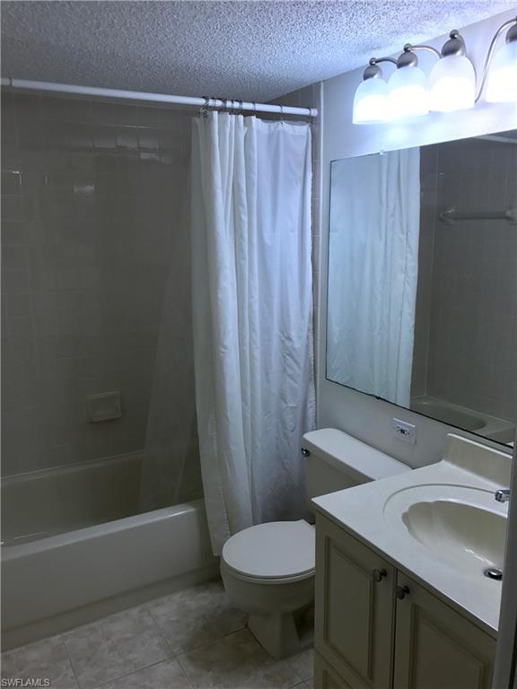 2214 Arbour Walk Circle, Unit 2012 Naples, FL 34109 - Photo 12 of 17 a bathroom with a sink toilet and shower