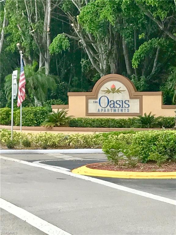 2214 Arbour Walk Circle, Unit 2012 Naples, FL 34109 - Photo 17 of 17 a view of park with sign board and yard