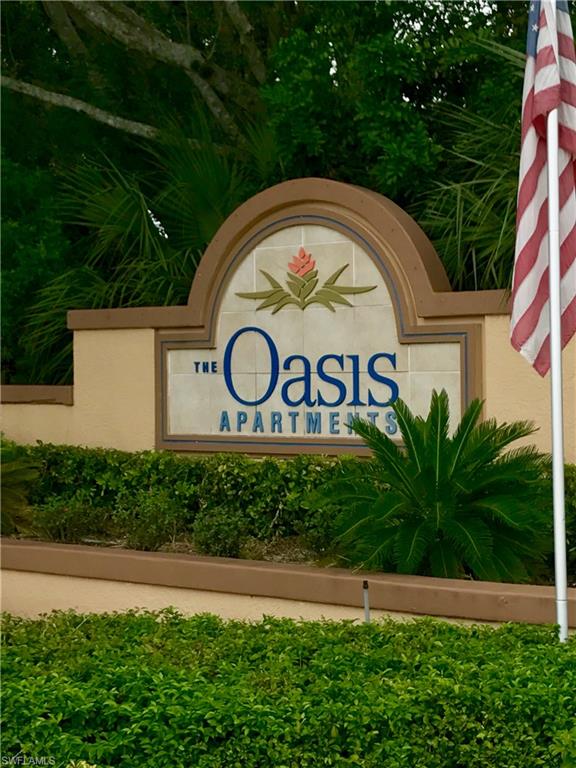 2214 Arbour Walk Circle, Unit 2012 Naples, FL 34109 - Photo 2 of 17 a sign that is on the side of a building