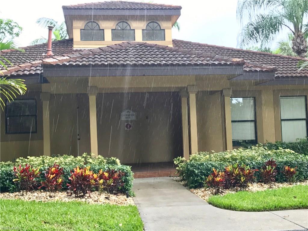 2214 Arbour Walk Circle, Unit 2012 Naples, FL 34109 - Photo 3 of 17 a front view of a house with a garden