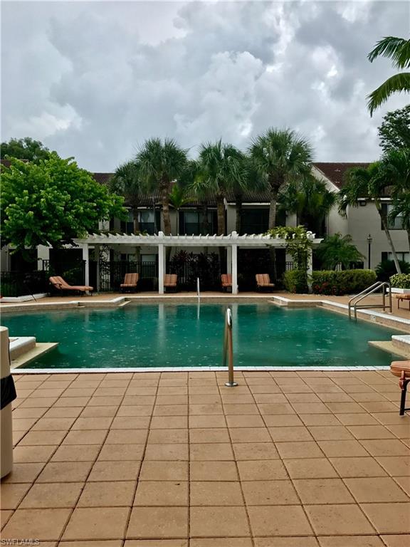 2214 Arbour Walk Circle, Unit 2012 Naples, FL 34109 - Photo 4 of 17 a view of a backyard