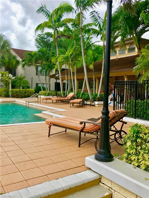2214 Arbour Walk Circle, Unit 2012 Naples, FL 34109 - Photo 5 of 17 a park with bench and trees