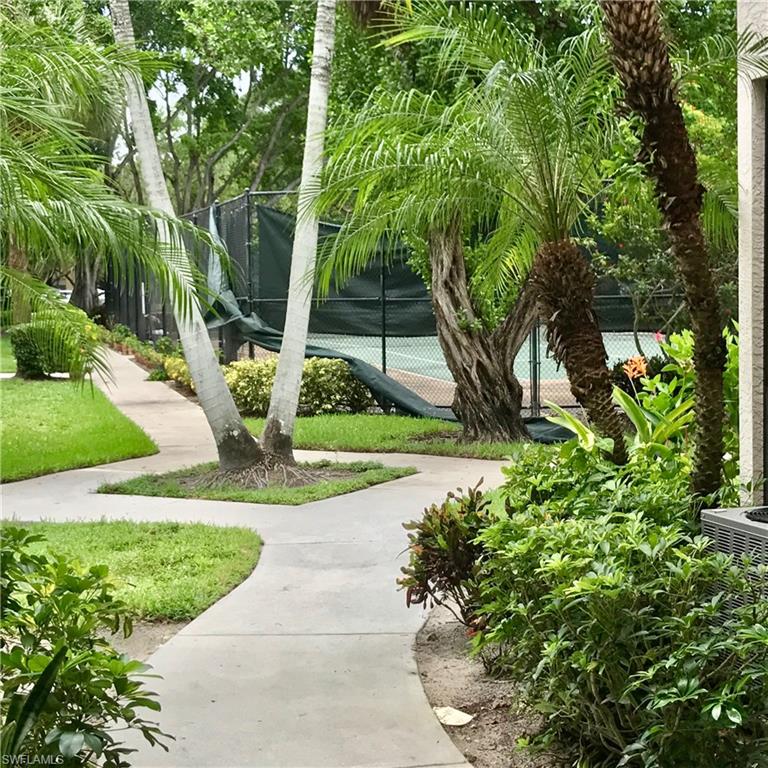 2214 Arbour Walk Circle, Unit 2012 Naples, FL 34109 - Photo 8 of 17 a view of a garden with plants