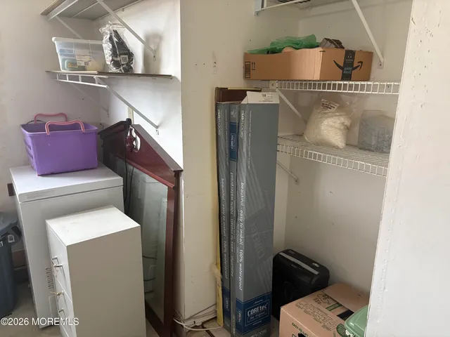 a view of a hallway with furniture