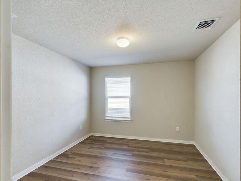 114 Cranbrook Lane Hutto, TX 78634 - Photo 13 of 38 Spare room with dark hardwood / wood-style floors and a textured ceiling