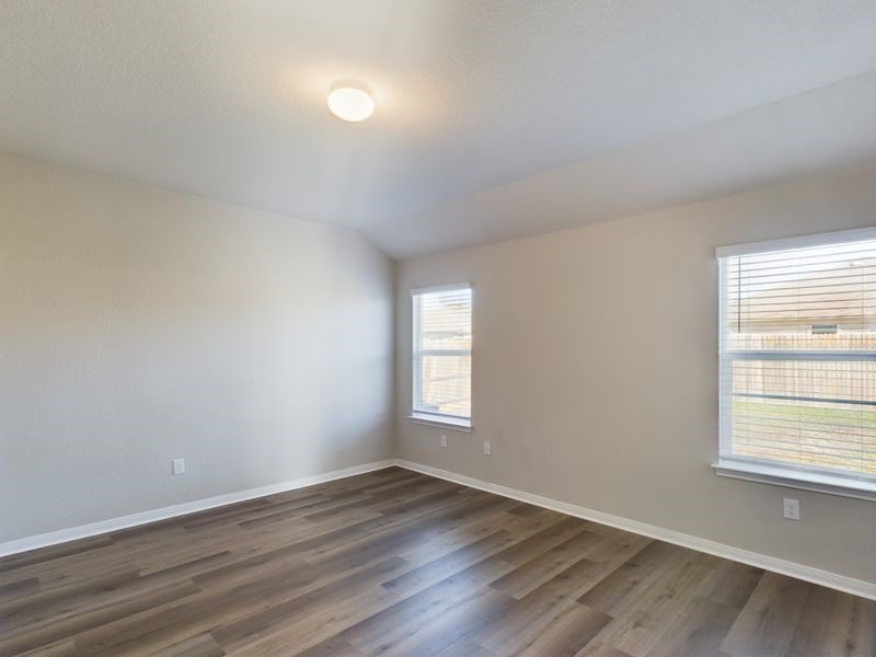 114 Cranbrook Lane Hutto, TX 78634 - Photo 19 of 38 Spare room with dark hardwood / wood-style flooring and vaulted ceiling