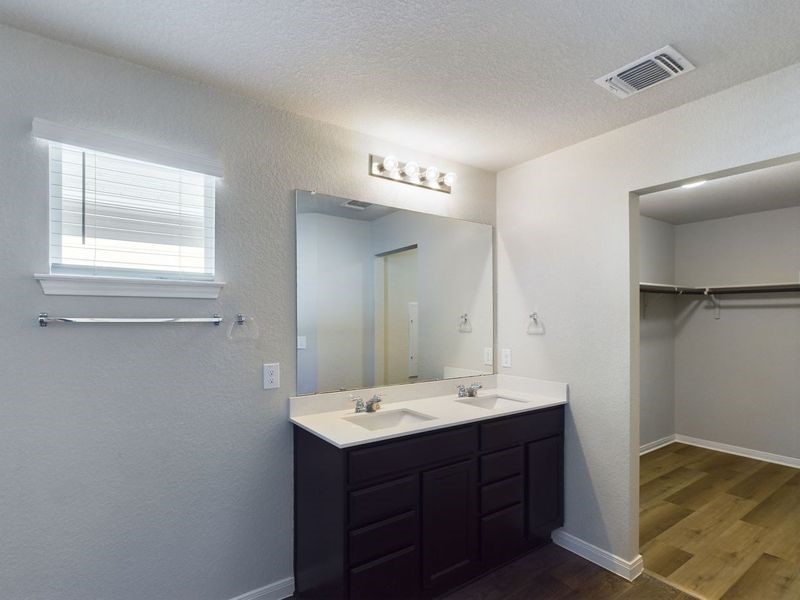 114 Cranbrook Lane Hutto, TX 78634 - Photo 35 of 38 Bathroom featuring a textured ceiling, hardwood / wood-style floors, and vanity