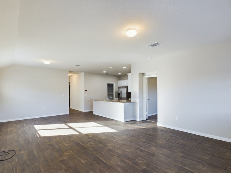 114 Cranbrook Lane Hutto, TX 78634 - Photo 7 of 38 Unfurnished living room with dark hardwood / wood-style floors