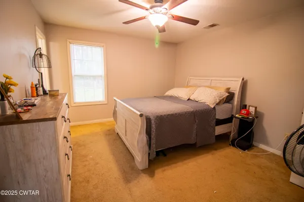 a bed room with a bed and a chandelier