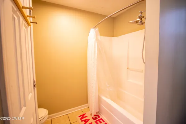 a bathroom with a shower and a bathtub