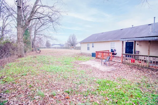 a view of a backyard with table and chairs under an umbrella