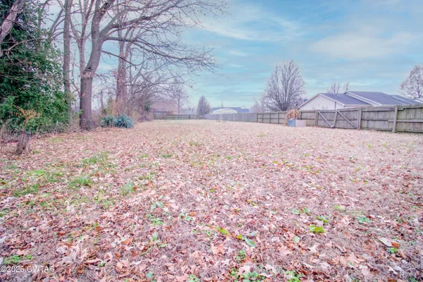 a backyard of a house with a yard and garage