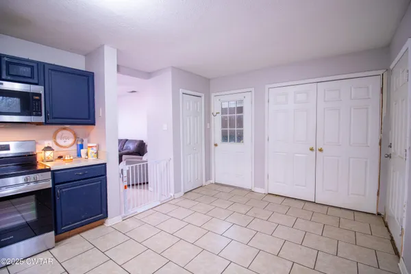 a kitchen with granite countertop a stove top oven and cabinets
