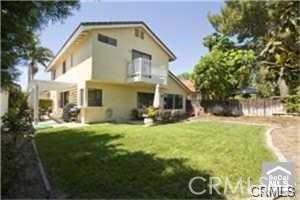 3 Atlanta Irvine, CA 92620 - Photo 3 of 3 a view of a white house with a big yard and large trees