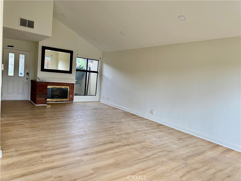 3 Atlanta Irvine, CA 92620 - Photo 4 of 14 a view of an empty room with wooden floor and a window