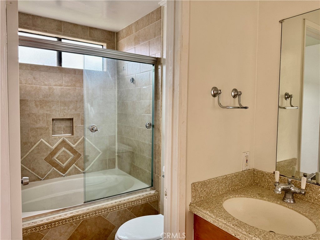 3 Atlanta Irvine, CA 92620 - Photo 6 of 14 a bathroom with a granite countertop bathtub shower sink mirror and toilet